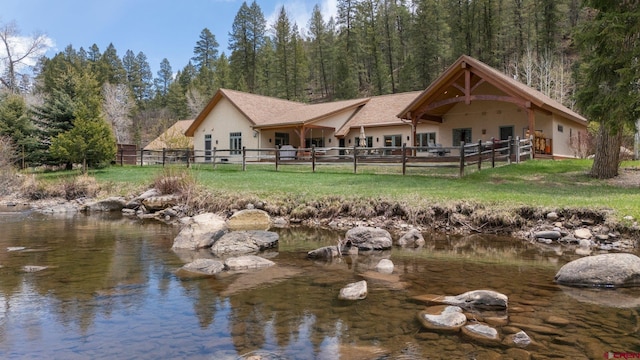 99 River Rd, Durango, CO 81301 - rear view of property with stucco siding and a wooded view