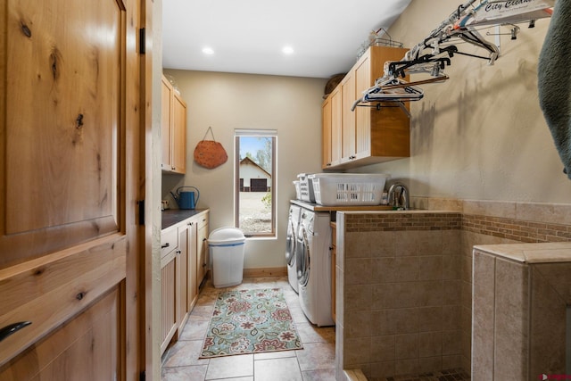 99 River Rd, Durango, CO 81301 - washroom featuring cabinet space, washer and dryer, light tile patterned floors, and recessed lighting