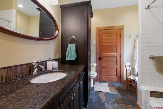 99 River Rd, Durango, CO 81301 - full bathroom featuring stone finish flooring, vanity, and toilet