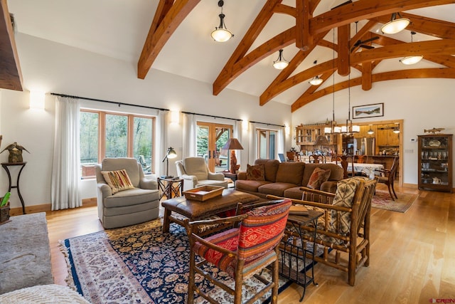 99 River Rd, Durango, CO 81301 - living area with beam ceiling, high vaulted ceiling, light wood finished floors, and baseboards