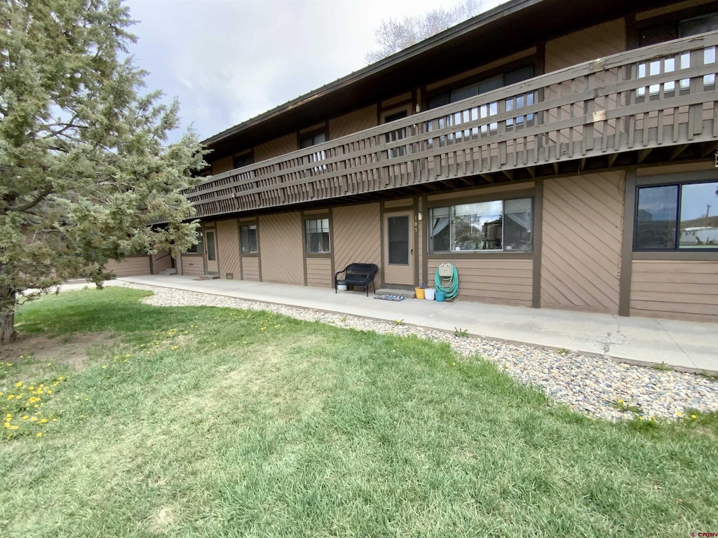 212 S 11th St Unit 105, Gunnison, CO 81230 - rear view of house featuring a lawn