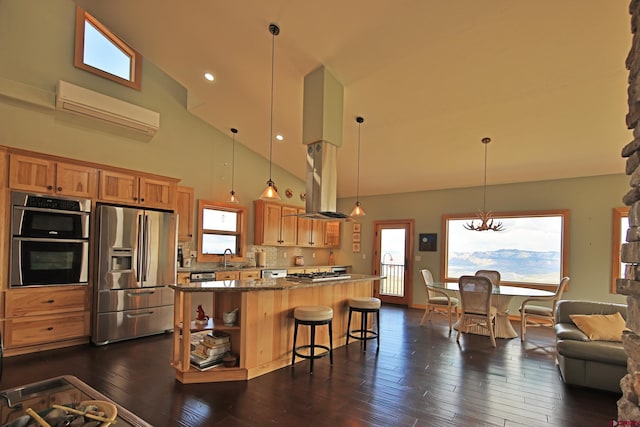 53315 Bull Basin Rd, Mesa, CO 81643 - kitchen featuring stainless steel appliances, high vaulted ceiling, an AC wall unit, a center island, and dark wood-style floors