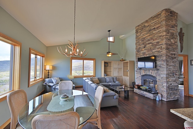 53315 Bull Basin Rd, Mesa, CO 81643 - dining space with hardwood / wood-style floors, a chandelier, a stone fireplace, baseboards, and a ceiling fan