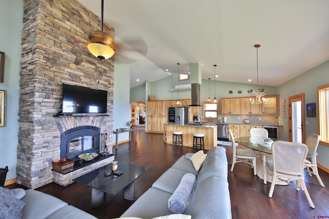 53315 Bull Basin Rd, Mesa, CO 81643 - living room with a chandelier, dark wood-style floors, a fireplace, baseboards, and high vaulted ceiling