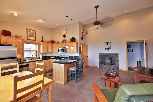 53315 Bull Basin Rd, Mesa, CO 81643 - kitchen featuring appliances with stainless steel finishes, open floor plan, a sink, a towering ceiling, and light brown cabinetry