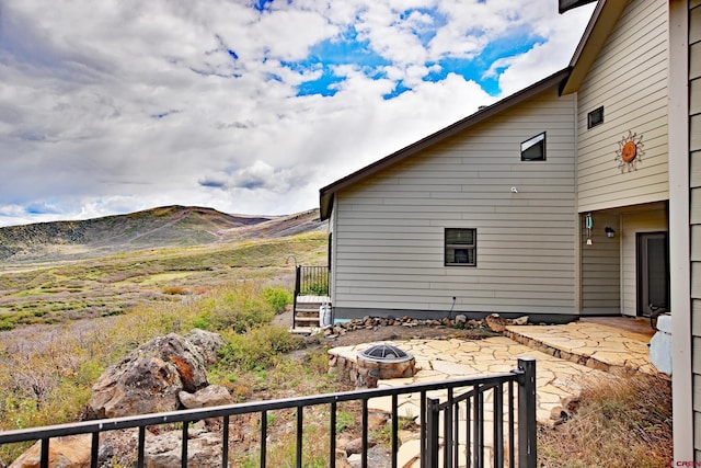 53315 Bull Basin Rd, Mesa, CO 81643 - view of side of property featuring an outdoor fire pit, a patio area, and a mountain view