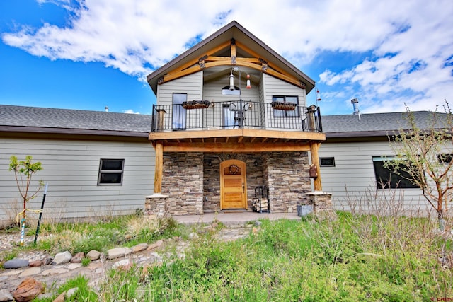 53315 Bull Basin Rd, Mesa, CO 81643 - view of front facade featuring stone siding, a balcony, and roof with shingles