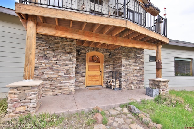 53315 Bull Basin Rd, Mesa, CO 81643 - view of exterior entry featuring stone siding and a balcony