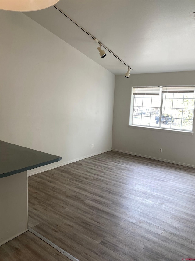 240 S Madison St, Cortez, CO 81321 - unfurnished room with dark wood-style floors, track lighting, and baseboards