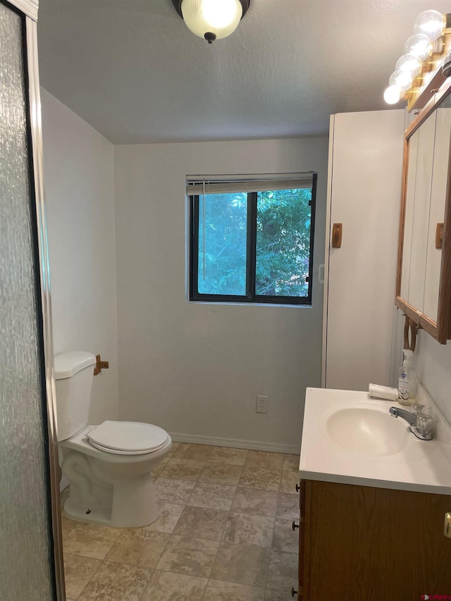145 S Madison St, Cortez, CO 81321 - bathroom featuring toilet, vanity, and baseboards