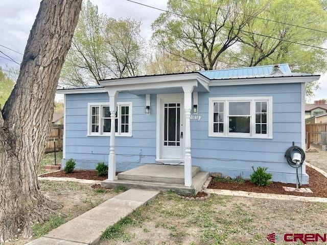 1414 Bluff St, Delta, CO 81416 - bungalow-style home featuring fence and metal roof