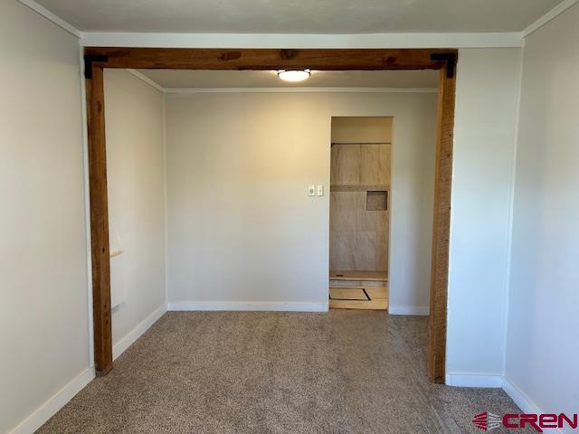 1414 Bluff St, Delta, CO 81416 - empty room featuring carpet and baseboards