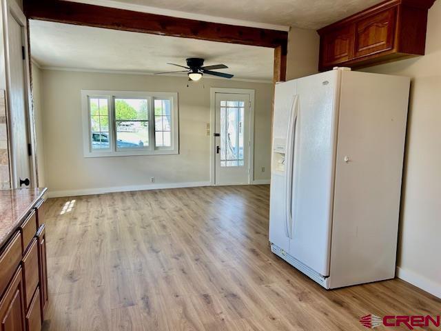 1414 Bluff St, Delta, CO 81416 - kitchen with white refrigerator with ice dispenser, beam ceiling, light wood finished floors, ceiling fan, and baseboards