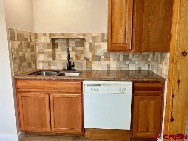 1414 Bluff St, Delta, CO 81416 - kitchen with dishwasher, a sink, tasteful backsplash, brown cabinets, and dark stone countertops
