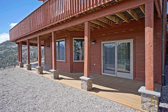 view of side of home with a deck with mountain view
