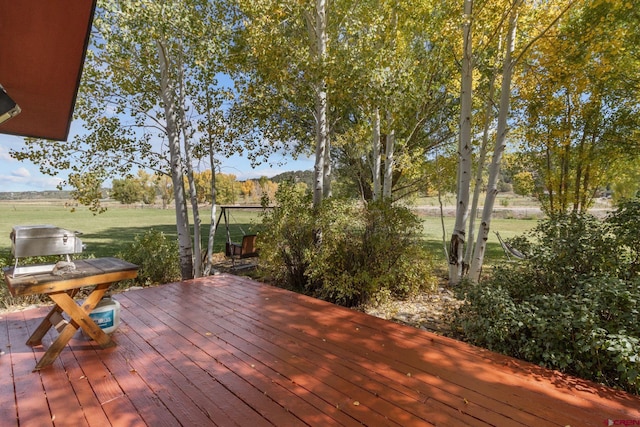wooden deck featuring a yard