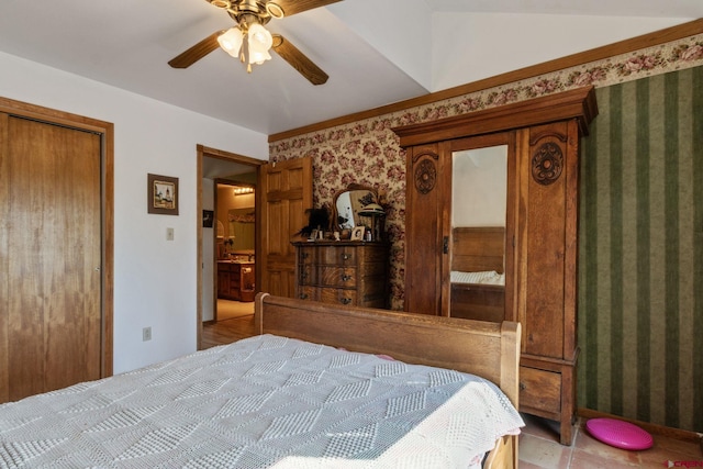 bedroom with wallpapered walls and a ceiling fan