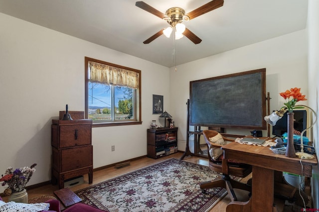 office with ceiling fan, baseboards, and wood finished floors