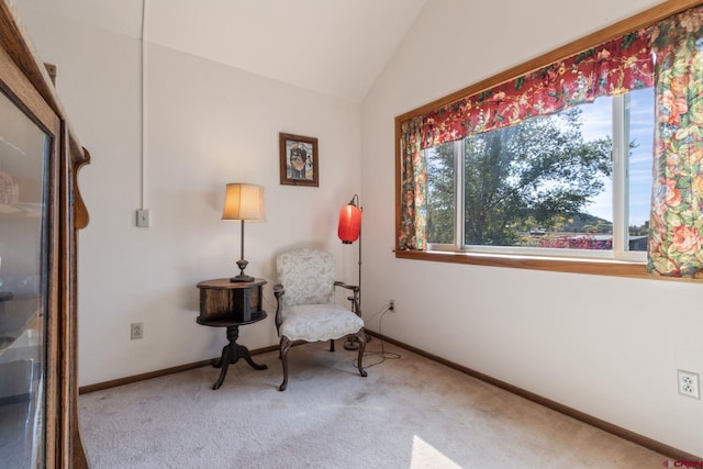 living area featuring carpet floors, vaulted ceiling, and baseboards