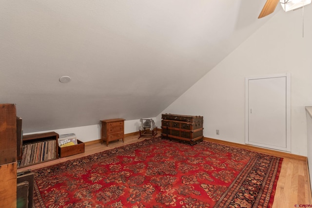 additional living space featuring wood finished floors and vaulted ceiling