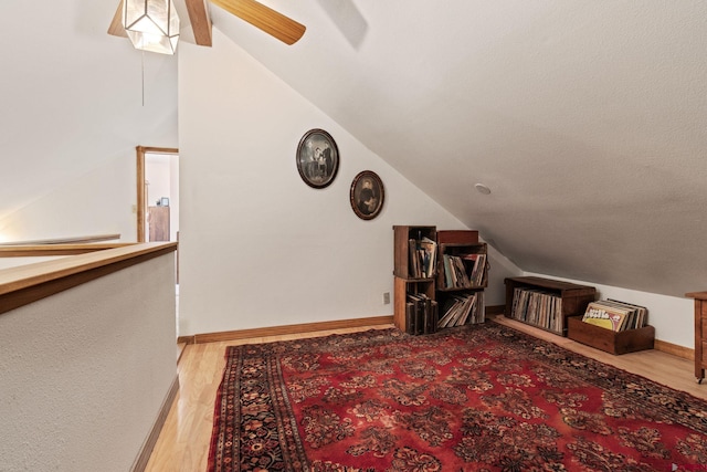 bonus room featuring vaulted ceiling, a ceiling fan, wood finished floors, and baseboards