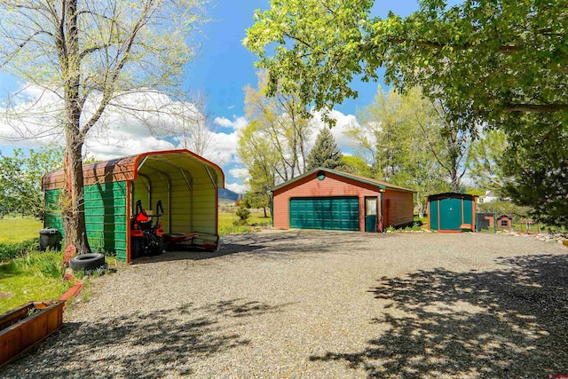 detached garage with a storage unit and a carport