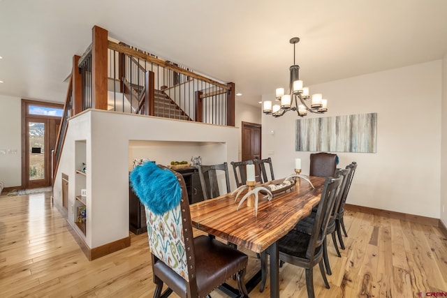 32 Cinnamon Mountain Rd, Mount Crested Butte, CO 81225 - dining space with a chandelier, baseboards, light wood-type flooring, and stairway