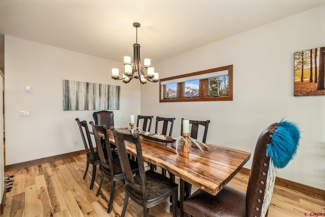 32 Cinnamon Mountain Rd, Mount Crested Butte, CO 81225 - dining area with a chandelier, light wood finished floors, and baseboards