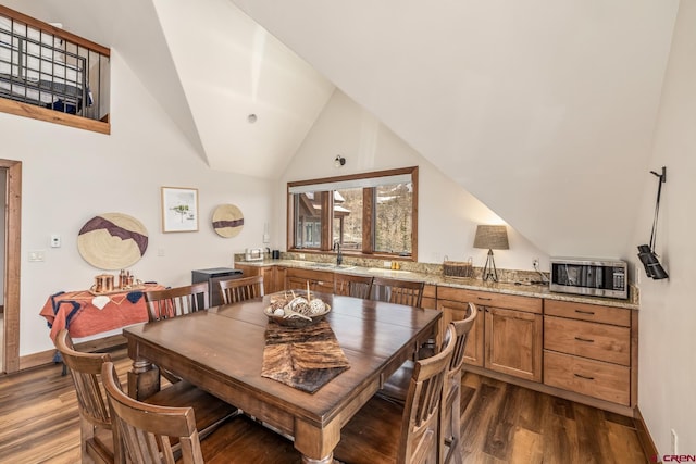 32 Cinnamon Mountain Rd, Mount Crested Butte, CO 81225 - dining space featuring dark wood-style flooring, lofted ceiling, and baseboards
