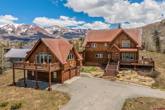 32 Cinnamon Mountain Rd, Mount Crested Butte, CO 81225 - view of front of property with asphalt driveway, metal roof, and a deck with mountain view