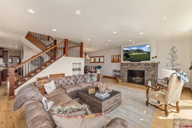 32 Cinnamon Mountain Rd, Mount Crested Butte, CO 81225 - living room featuring wood finished floors, recessed lighting, stairway, a chandelier, and a stone fireplace