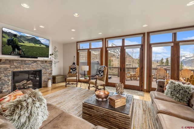 32 Cinnamon Mountain Rd, Mount Crested Butte, CO 81225 - living area featuring wood finished floors, recessed lighting, expansive windows, and a stone fireplace