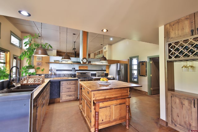 10491 54 7/10 Rd, Molina, CO 81646 - kitchen with appliances with stainless steel finishes, butcher block countertops, open shelves, a sink, and a kitchen island