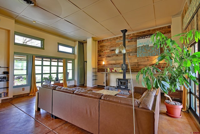 10491 54 7/10 Rd, Molina, CO 81646 - living room featuring a wood stove, a paneled ceiling, and concrete flooring
