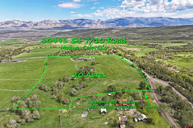 10491 54 7/10 Rd, Molina, CO 81646 - aerial view of property's location featuring a mountain backdrop and property boundaries highlighted