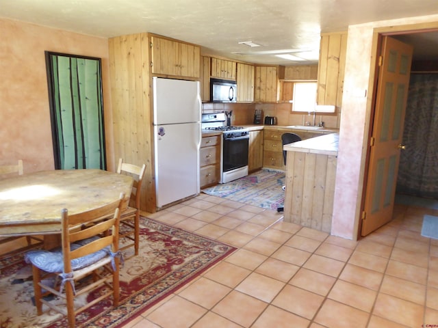 858 Reese St, Silverton, CO 81433 - kitchen featuring white appliances, a sink, light brown cabinetry, and light tile patterned floors