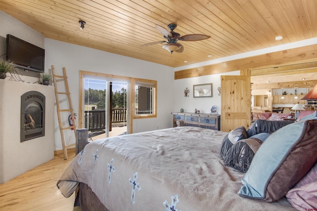 584 Oren Rd, Pagosa Springs, CO 81147 - bedroom featuring access to outside, wood finished floors, wood ceiling, a fireplace, and ceiling fan