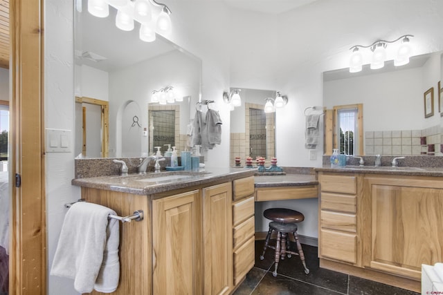 584 Oren Rd, Pagosa Springs, CO 81147 - bathroom featuring decorative backsplash and two vanities