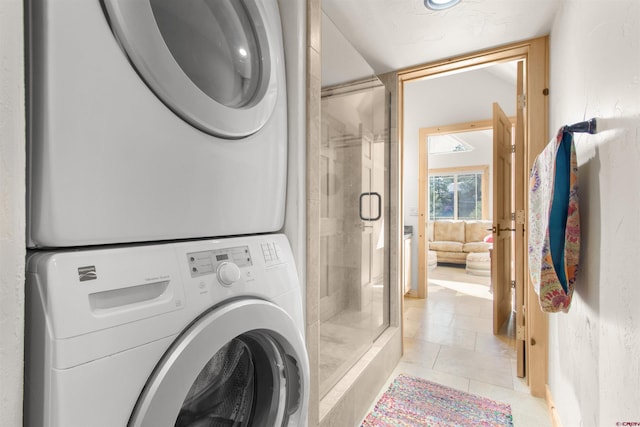 584 Oren Rd, Pagosa Springs, CO 81147 - laundry area featuring stacked washing machine and dryer and light tile patterned floors