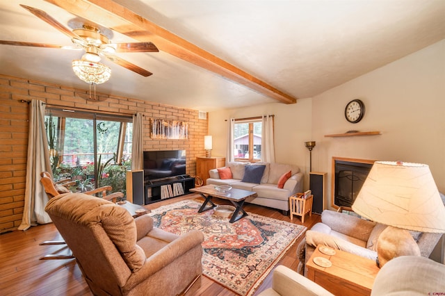 520 Los Ranchitos Dr, Durango, CO 81301 - living room with beamed ceiling, brick wall, wood finished floors, and ceiling fan
