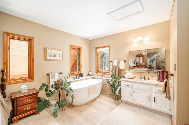 520 Los Ranchitos Dr, Durango, CO 81301 - bathroom featuring a soaking tub, vanity, and wood finished floors