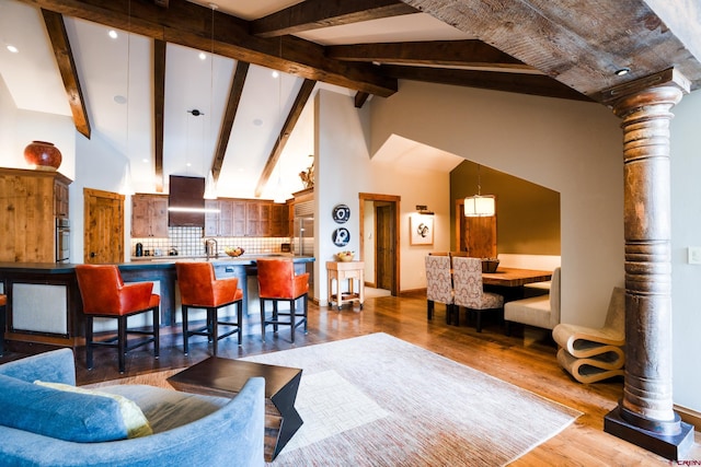 living room featuring dark wood-style floors, beamed ceiling, high vaulted ceiling, baseboards, and recessed lighting