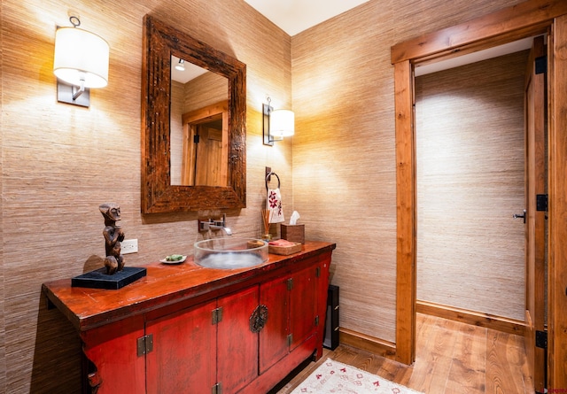 bathroom featuring wood finished floors, vanity, and baseboards