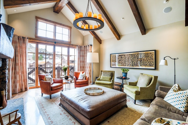 living area with high vaulted ceiling, beamed ceiling, and wood finished floors