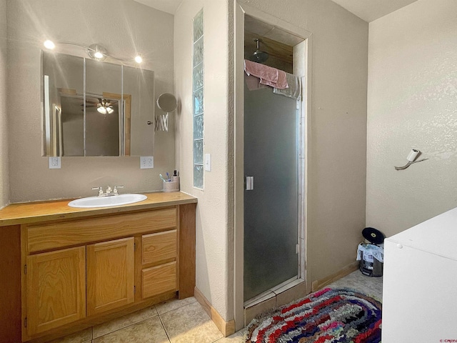 175 County Road J6, Egnar, CO 81325 - bathroom with a stall shower, vanity, tile patterned floors, baseboards, and a ceiling fan
