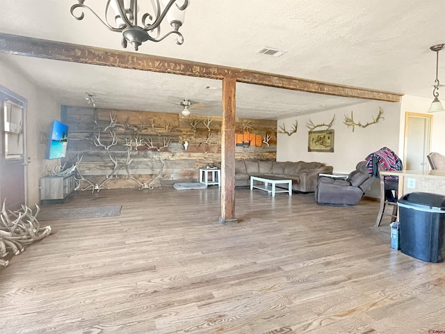 175 County Road J6, Egnar, CO 81325 - living room featuring wood finished floors, a textured ceiling, ceiling fan, and a chandelier