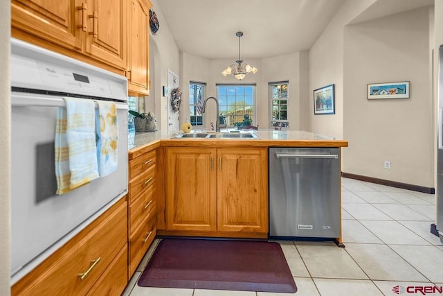 1060 Alta Vista Dr, Craig, CO 81625 - kitchen featuring dishwasher, a sink, a peninsula, a chandelier, and oven