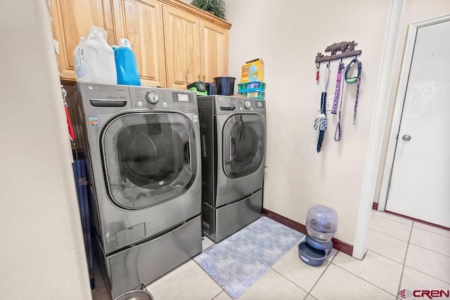 1060 Alta Vista Dr, Craig, CO 81625 - laundry area with separate washer and dryer, cabinet space, light tile patterned flooring, and baseboards