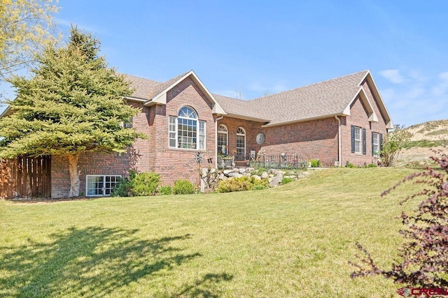 1060 Alta Vista Dr, Craig, CO 81625 - view of front of property with brick siding, a front lawn, and a shingled roof