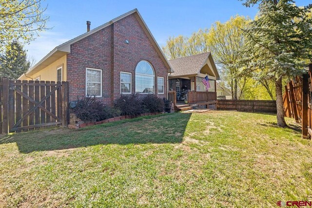 1060 Alta Vista Dr, Craig, CO 81625 - view of front facade featuring brick siding, a gate, and a deck